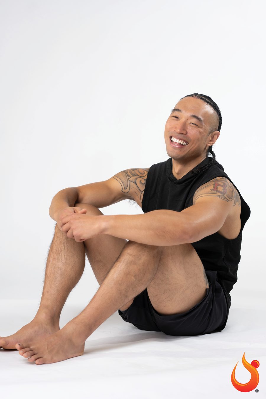 Chris seated on a studio floor, laughing