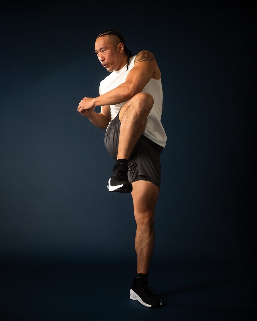 Chris driving a knee in an editorial studio portrait