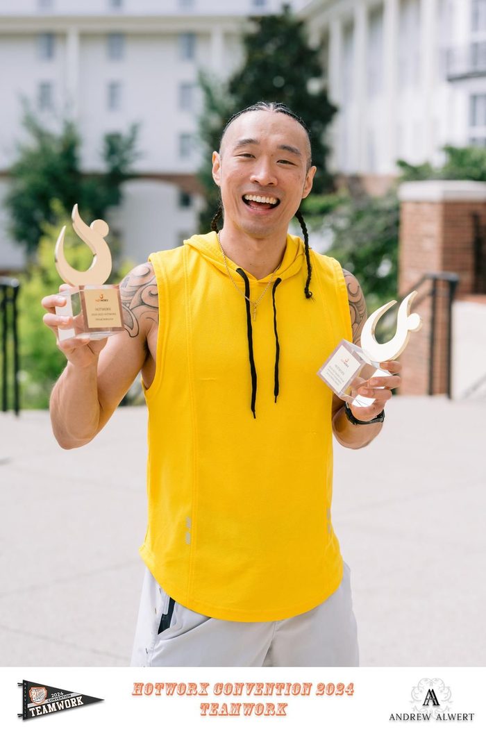 Chris holding two Hotworx awards at the 2024 convention